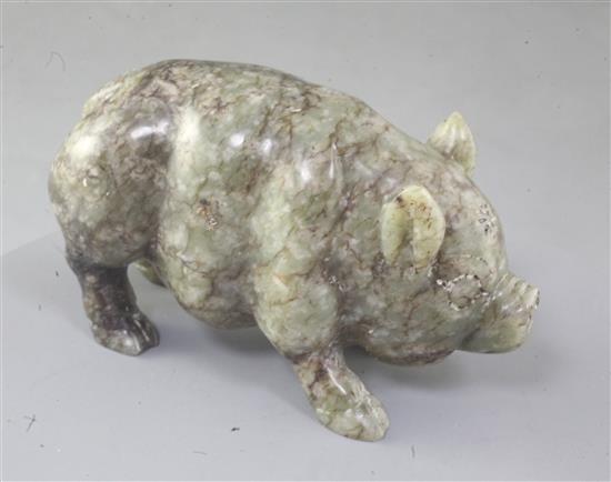 A Chinese celadon and brown jade figure of a pig, standing on all fours, length 10.7cm